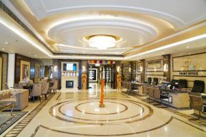 a salon with a large ceiling with a large fountain at Hotel Shubham Palace in Surūrnagar