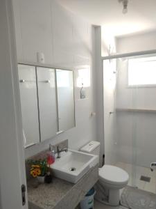 a white bathroom with a sink and a toilet at Praia canavieiras in Florianópolis +93 photos