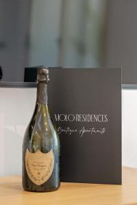 a bottle of wine sitting on top of a table at Molo Residences Boutique Apartments & Spa in Marbella
