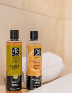 two bottles of orange juice sitting on a shelf at Molo Residences Boutique Apartments & Spa in Marbella