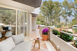 a home with a porch with a couch and flowers at Molo Residences Boutique Apartments & Spa in Marbella