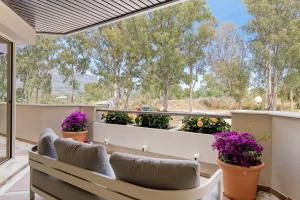a balcony with a bench and flowers on it at Molo Residences Boutique Apartments & Spa in Marbella +102 photos