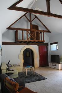 a living room with a couch and a tv at La Longère du Manoir in Laniscat +24 photos
