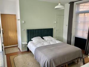 Ένα ή περισσότερα κρεβάτια σε δωμάτιο στο La Parcelle
