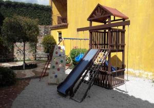 a playground with a slide and a play structure at Art Deco Loft - PetFriendly - 5 Min to Antigua Ctr in Antigua Guatemala