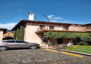 a car parked in a parking lot in front of a house at Art Deco Loft - PetFriendly - 5 Min to Antigua Ctr in Antigua Guatemala