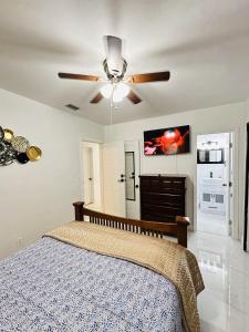 a bedroom with a bed and a ceiling fan at Miami Casa in Miami Gardens
