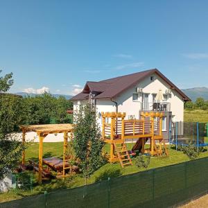 a house with a table and chairs in the yard at Villa 'Whispering Pines' Ilidža in Sarajevo