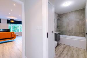 a bathroom with a shower and a toilet and a sink at Elysée Suites - Lovely 2 Bed Flat in Southport in Southport