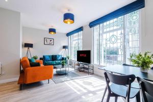 a living room with a couch and a table and chairs at Elysée Suites - Lovely 2 Bed Flat in Southport in Southport