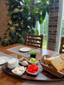 a wooden table with a tray of food on it at Mont Blanc Hotel in Peshkopi