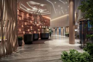 a lobby of a building with a large lobby with plants at Marriott Corrientes in Corrientes