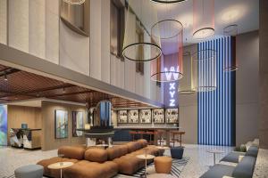 a lobby with couches and tables and a bar at Aloft by Marriott Istanbul Karakoy in Istanbul