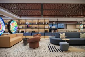 a lobby with couches and chairs in a room at Aloft by Marriott Istanbul Karakoy in Istanbul