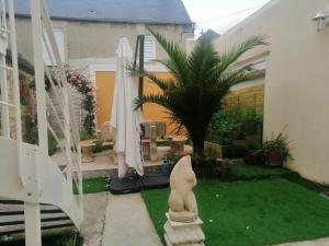a garden with a dog statue in the yard at D-DAY's in Bayeux