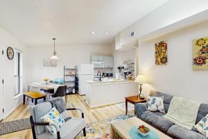 a living room with a couch and a kitchen at Tucked Away Getaway in Kimberling City
