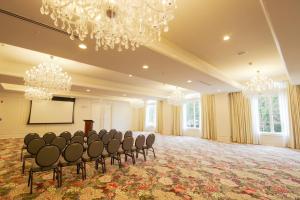 a large room with chairs and a screen and chandeliers at The Oliver, Oxford in Oxford
