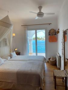 a bedroom with a bed and a view of the ocean at Casa Vora Mar in Felanitx +24 photos