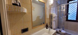 a bathroom with a sink and a mirror and a toilet at Alloggio Turistico Tedeschi in Santa Maria delle Mole