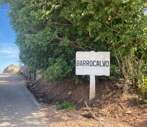 a sign on the side of a road at Ikigai B&B in Carvalhal
