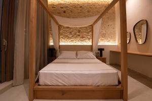 a bedroom with a canopy bed with white sheets at Madonna del Mare City in Chania +130 photos
