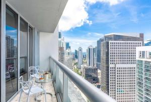 a balcony with two chairs and a table on it at MVR Bright & Airy Condo with Views in Miami