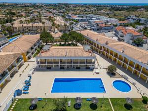 an aerial view of a building with a swimming pool at Pool&Beach in Encosta de São José in Albufeira