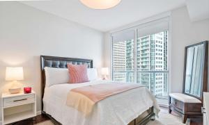 a white bedroom with a bed and a large window at MVR - Direct Bay View - Corner Smart TV in Miami