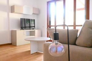 a living room with a couch and a table at S354 - Sirolo, comodo quadrilocale a 100mt dal centro in Sirolo