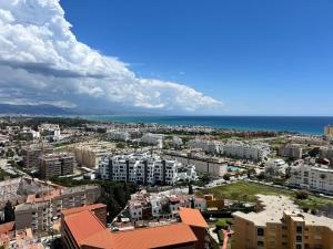 an aerial view of a city with buildings and the ocean at Apartamento Bellavista Close to the airport in Torremolinos