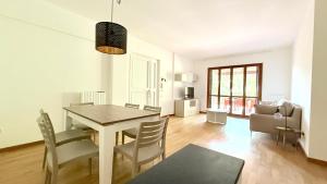 a dining room and living room with a table and chairs at S354 - Sirolo, comodo quadrilocale a 100mt dal centro in Sirolo