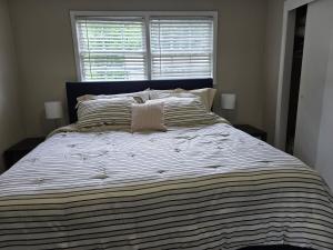 a large bed in a bedroom with a large window at Perfect flat in Central Fayetteville, GA in Fayetteville