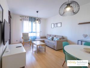 a living room with a couch and a table at Homity Holidays - Playa Granada - Dos Mares in Motril