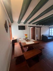 a living room with a wooden table and chairs at La Morada de la Villa 101 in Villa de Leyva