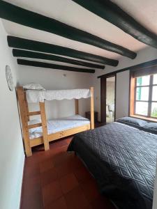a bedroom with a bed and a window at La Morada de la Villa 101 in Villa de Leyva +4 photos
