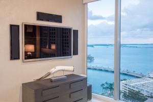 a room with a large window with a view of the ocean at MVR - Oceanfront Corner Balcony Luxe SPA in Miami