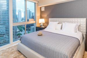 a bedroom with a large bed and a large window at MVR - Oceanfront Corner Balcony Luxe SPA in Miami