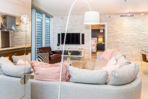 a living room with two couches and a tv at MVR - Oceanfront Corner Balcony Luxe SPA in Miami +18 photos