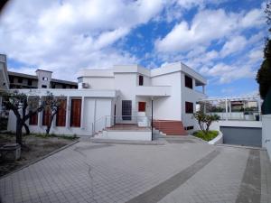 a white house with a driveway at Carachouse Pellaro in Pellaro