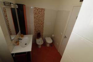 a small bathroom with a sink and a toilet at Casa Verde in Sant'Agnello +4 photos