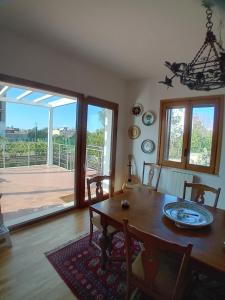 a dining room with a table and a large window at Carachouse Pellaro in Pellaro