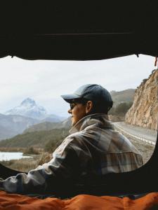 a man sitting in a truck looking out a window at Camper camioneta equipada cajon del maipo in San José de Maipo