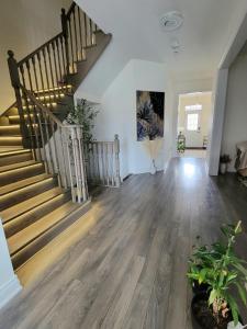 an empty living room with a staircase and a stair case at Luxury Suite - Master Bedroom in Niagara Falls