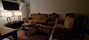 a living room with two couches and a tv at Ruma Inn Homestay Perlis in Gua Sai