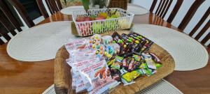 a basket of candy and snacks on a table at Ruma Inn Homestay Perlis in Gua Sai