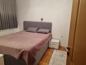 a bed with two pillows on it in a bedroom at VK Centar in Velika Kladuša