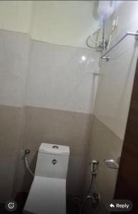 a small bathroom with a toilet and a shower at SREENILAYAM inn in Rājahmundry