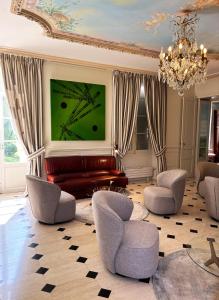 a living room with a couch and chairs at Château de Foussal in Issigeac