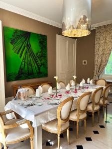 a dining room with a white table and chairs at Château de Foussal in Issigeac