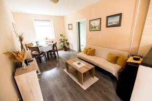 a living room with a couch and a table at Karlovci Hill Nook in Sremski Karlovci